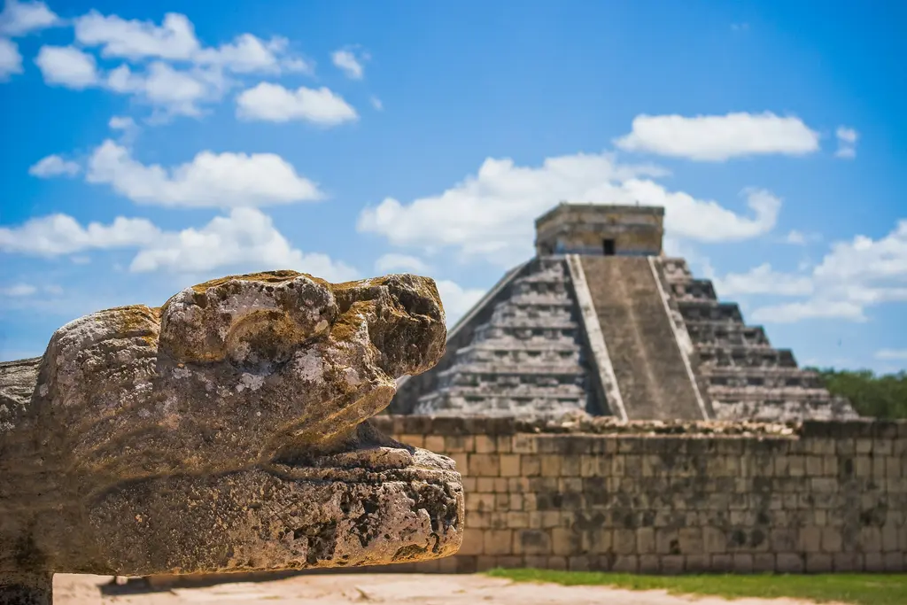 Feathered serpent head in front of El Castillo