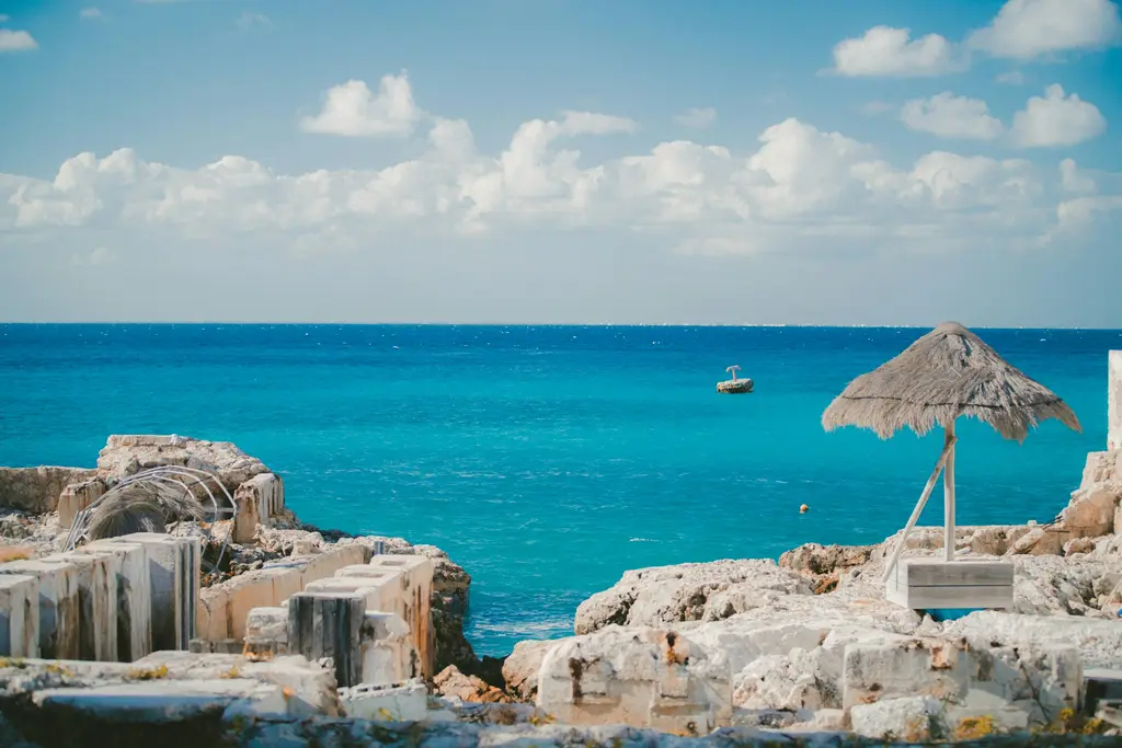 Rocky Cozumel coast with a palapa