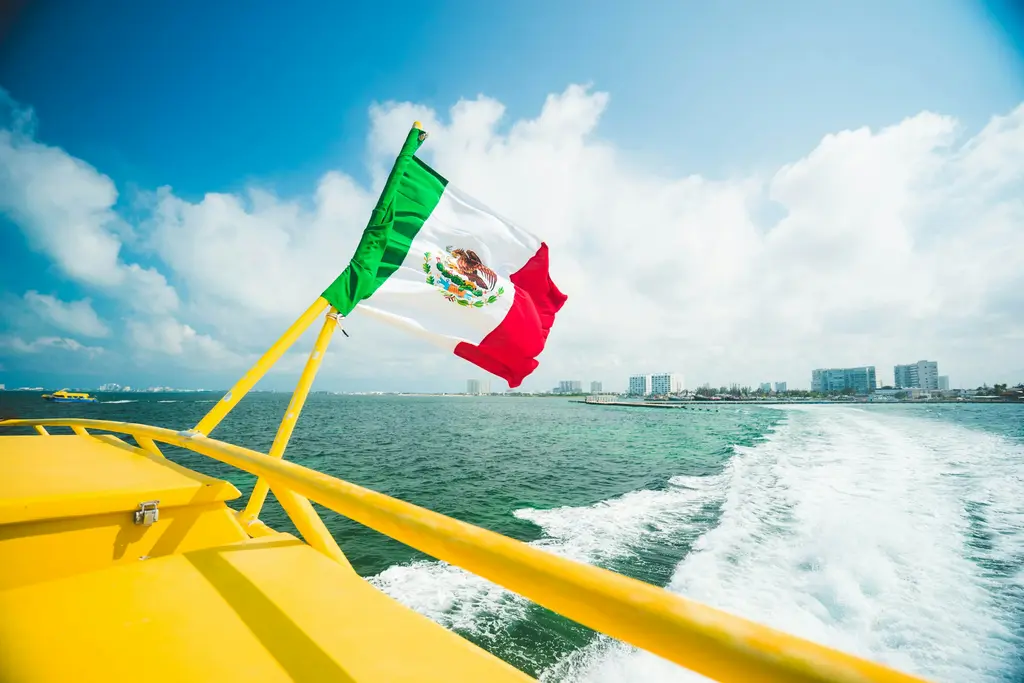 Mexican flag on a boat bow off Cancún