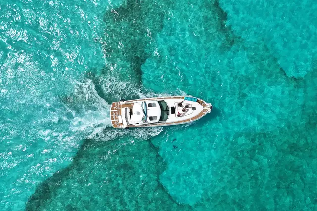 Aerial view of a yacht on turquoise water off Isla Mujeres