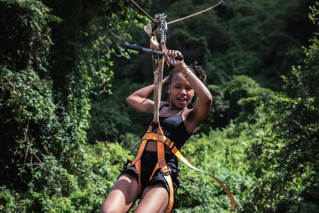 Woman on a zip line over the jungle